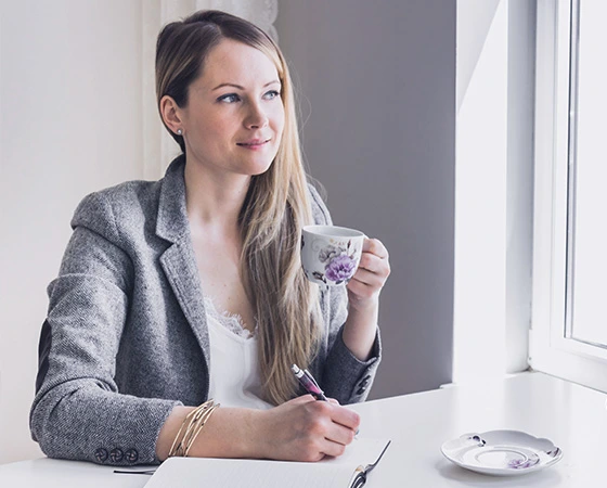 Kolléga kávézik és tollal a kezében tervez. Vezetői nyugdíjprogramok.